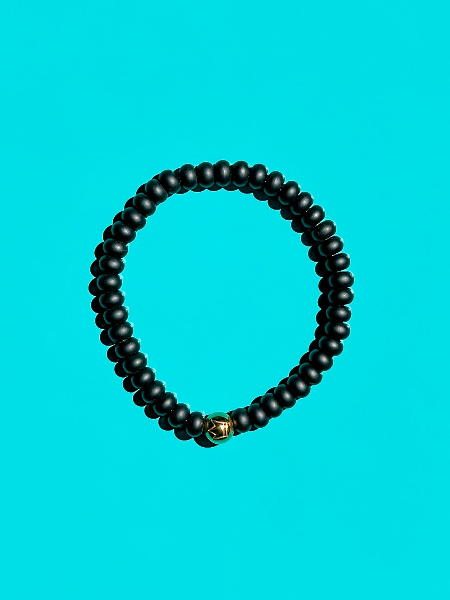 Men’s Bracelet with Onyx and gold over 316L stainless steel crown logo bead.