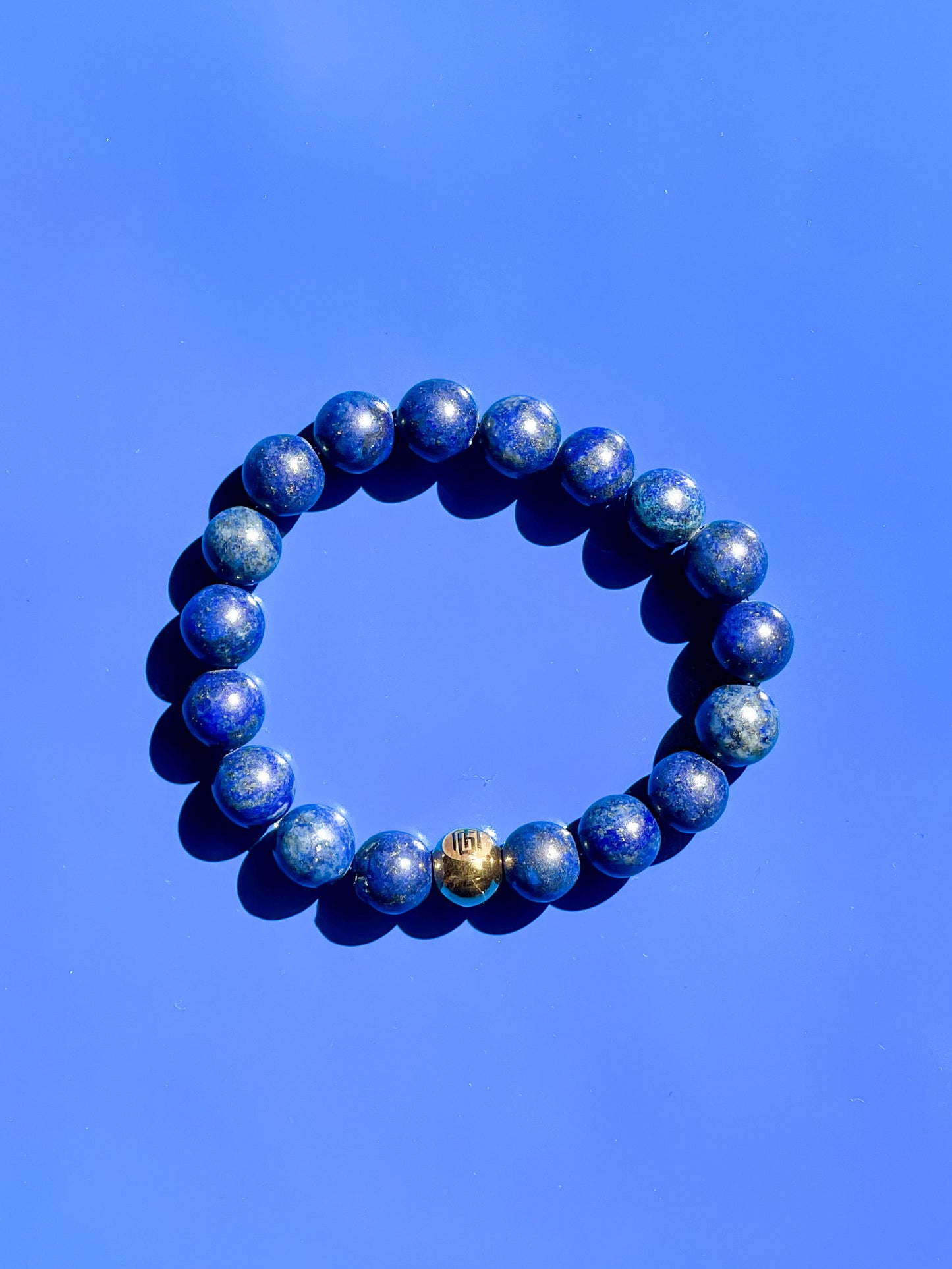 Men’s Bracelet with Lapis Lazuli and Gold plated over stainless steel logo beads.