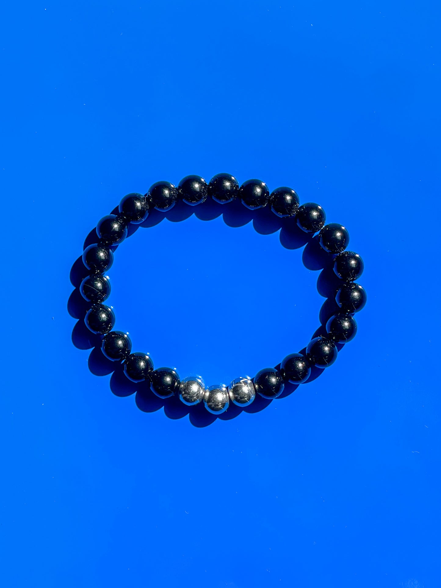 Men’s Bracelet with Onyx and stainless steel crown logo beads.