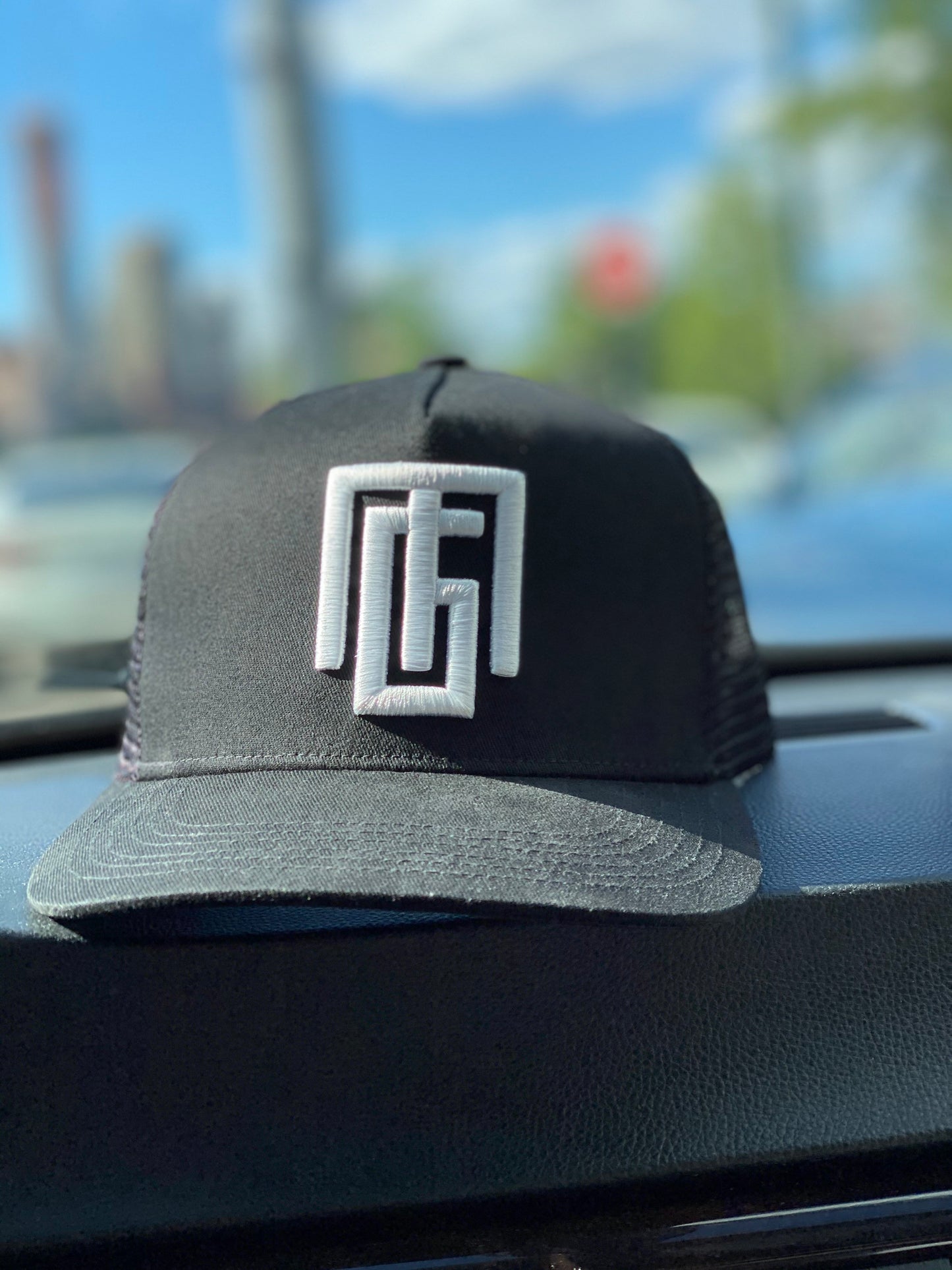 Black trucker hat with "Gregorio Mota" logo. Grgoriom Hats