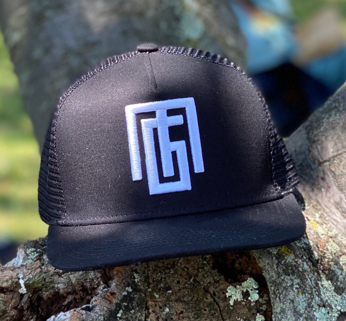 Black trucker hat with "Gregorio Mota" logo. Grgoriom Hats