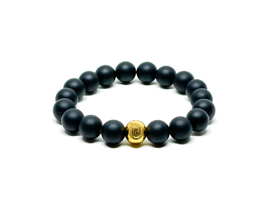 Men’s Bracelet with Matte Onyx and Gold plated over Stainless Steel logo bead.